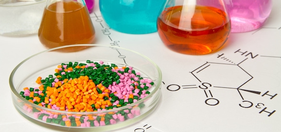 Plastic raw material in granules against the background of Chemical Laboratory and reagents. Polypropylene, Ethylene, Polypropylene research in laboratory conditions
